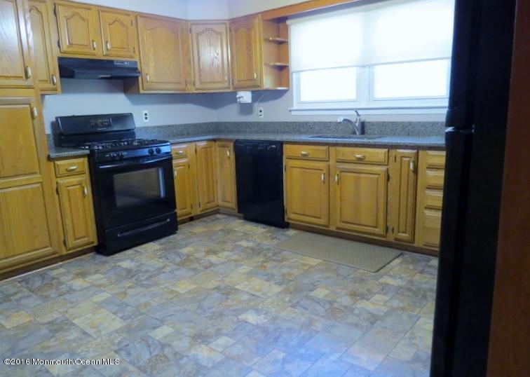 200 Bethany Road Hazlet, NJ 07730 - Photo 6 of 22 a kitchen with stainless steel appliances a stove a sink and a microwave