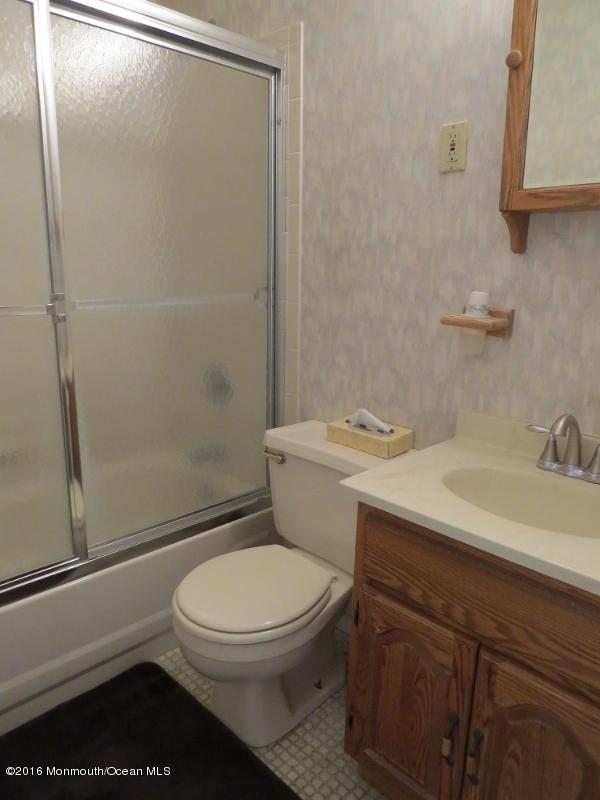 200 Bethany Road Hazlet, NJ 07730 - Photo 10 of 22 a bathroom with a sink a toilet and shower