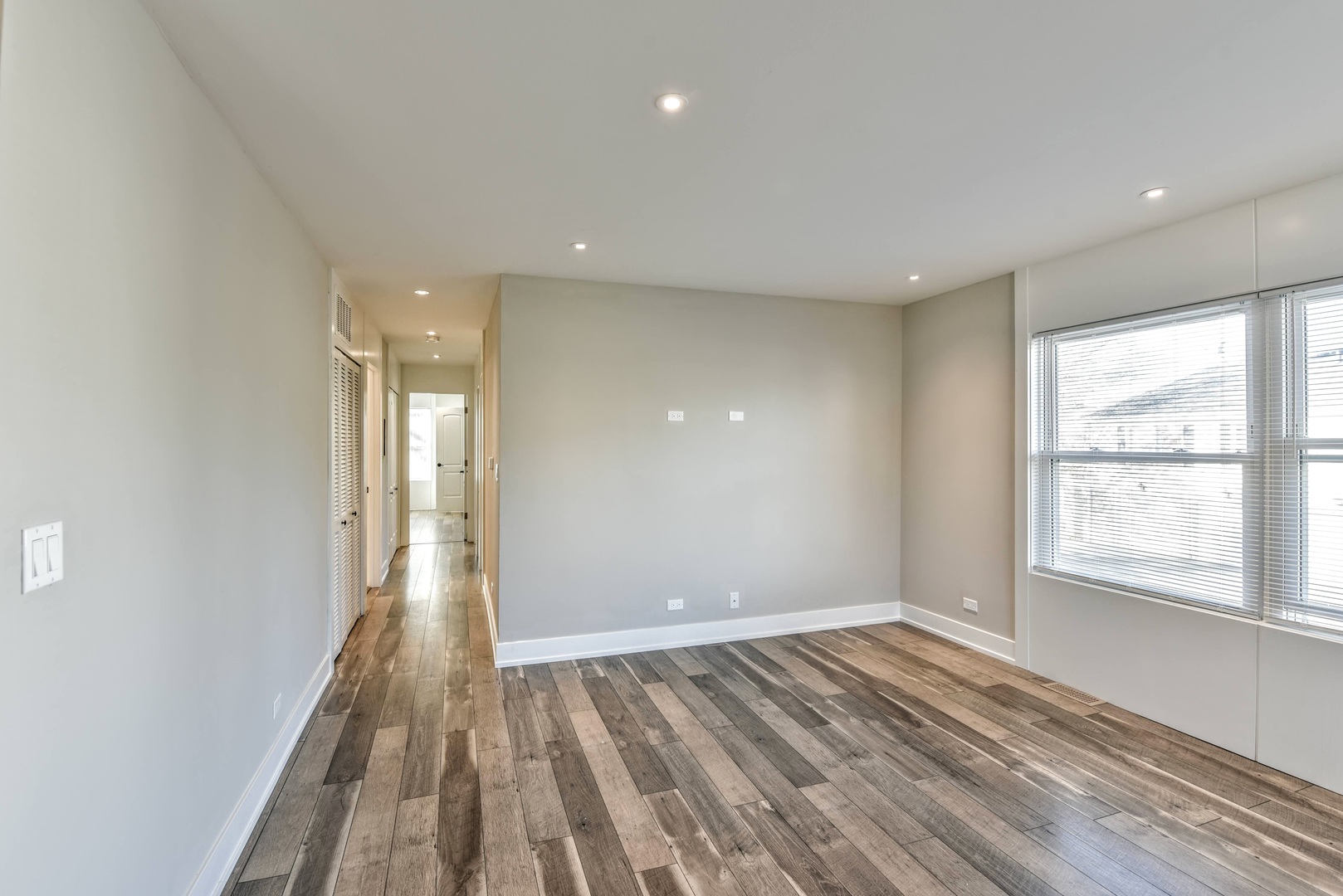 787 Pahl Road, Unit 787 Elk Grove Village, IL 60007 - Photo 11 of 28 wooden floor in an empty room with a window