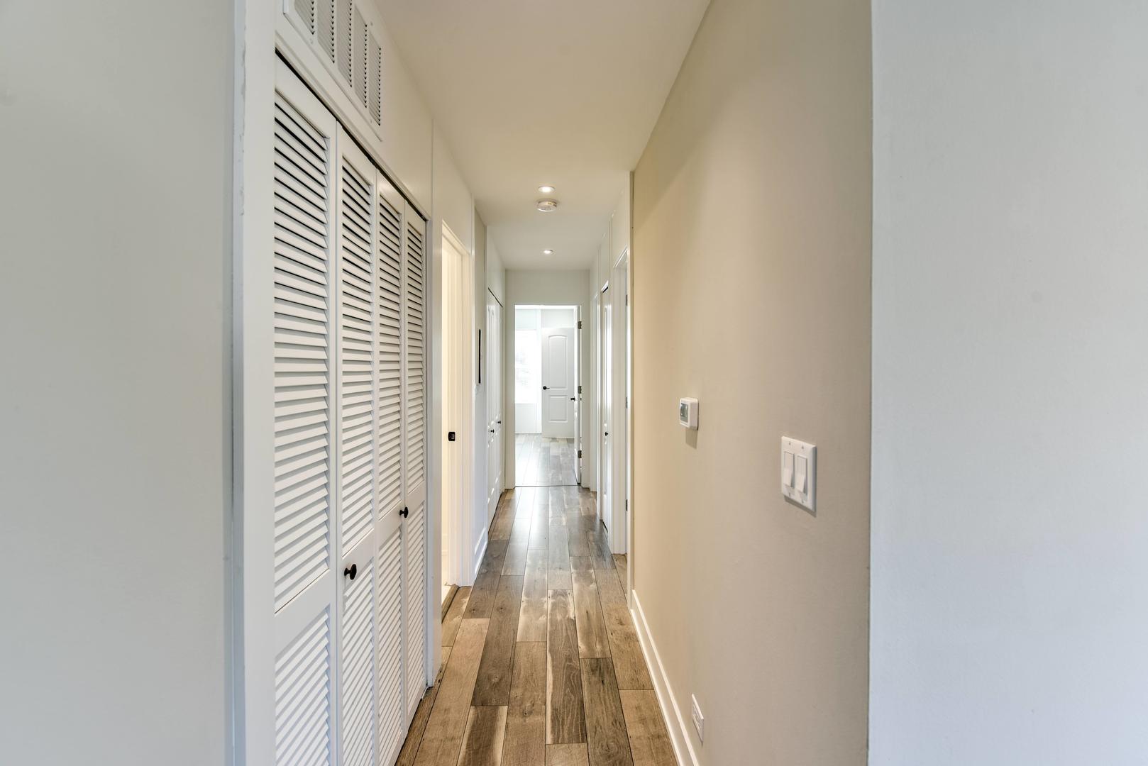 787 Pahl Road, Unit 787 Elk Grove Village, IL 60007 - Photo 13 of 28 a view of a hallway with a white walls