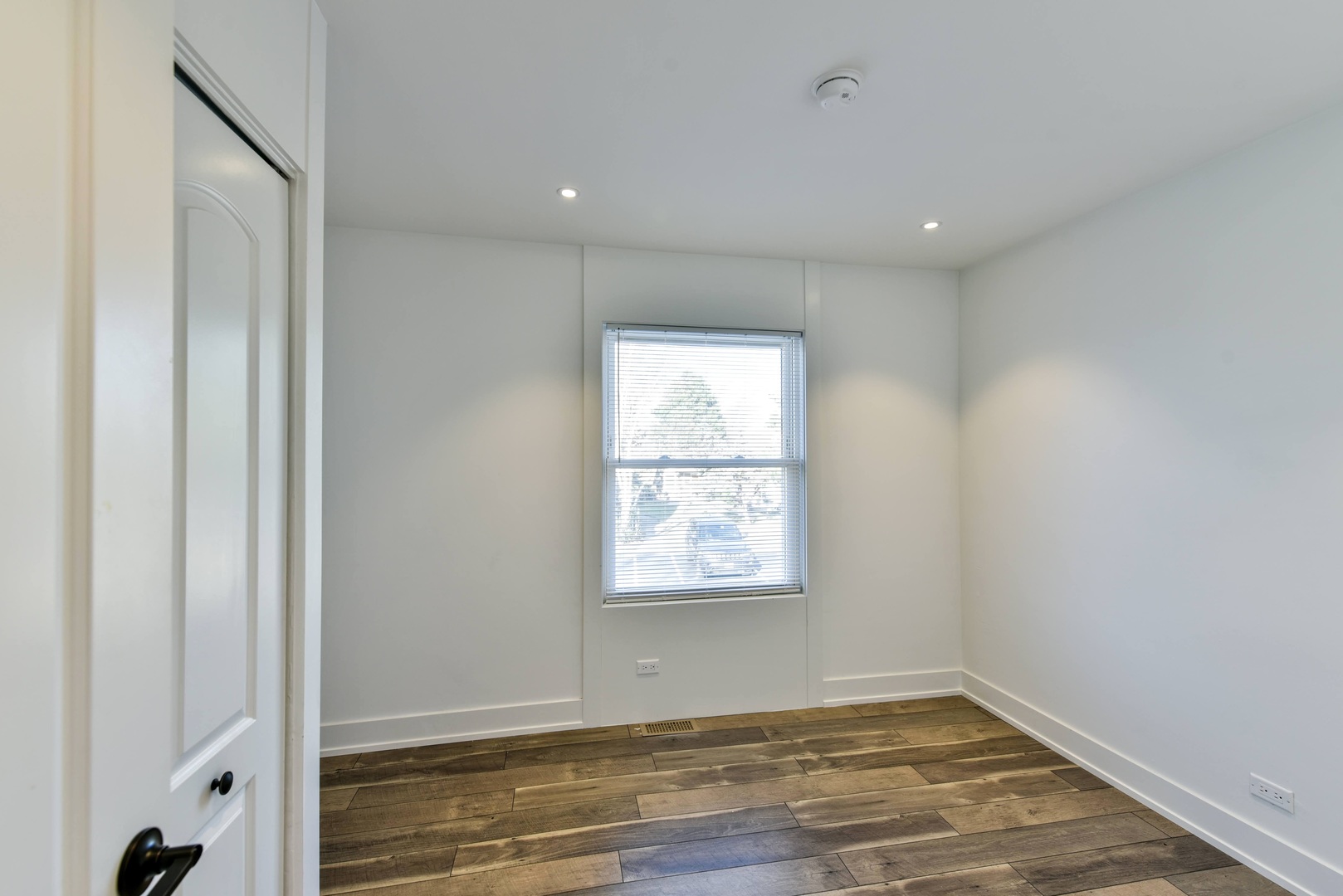787 Pahl Road, Unit 787 Elk Grove Village, IL 60007 - Photo 15 of 28 an empty room with wooden floor and windows