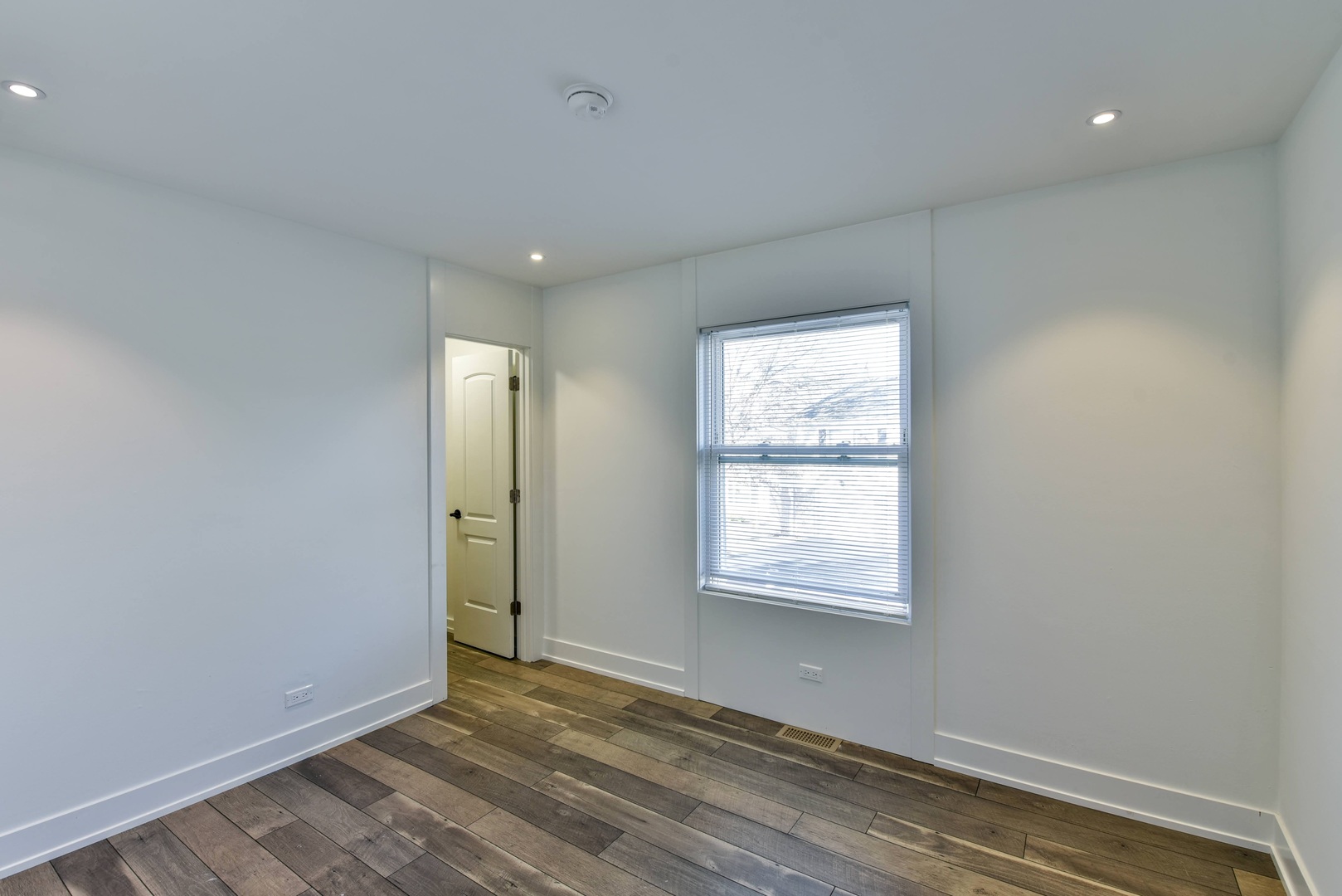 787 Pahl Road, Unit 787 Elk Grove Village, IL 60007 - Photo 18 of 28 an empty room with wooden floor and windows