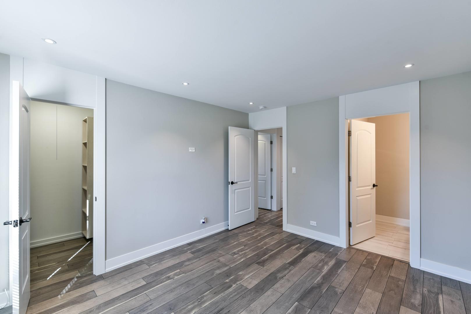 787 Pahl Road, Unit 787 Elk Grove Village, IL 60007 - Photo 22 of 28 a view of a livingroom with wooden floor and closet area