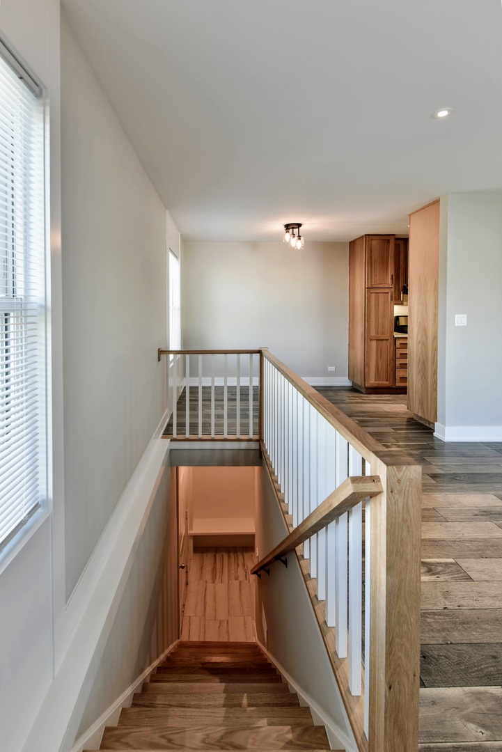 787 Pahl Road, Unit 787 Elk Grove Village, IL 60007 - Photo 5 of 28 a view of staircase with railing and white walls