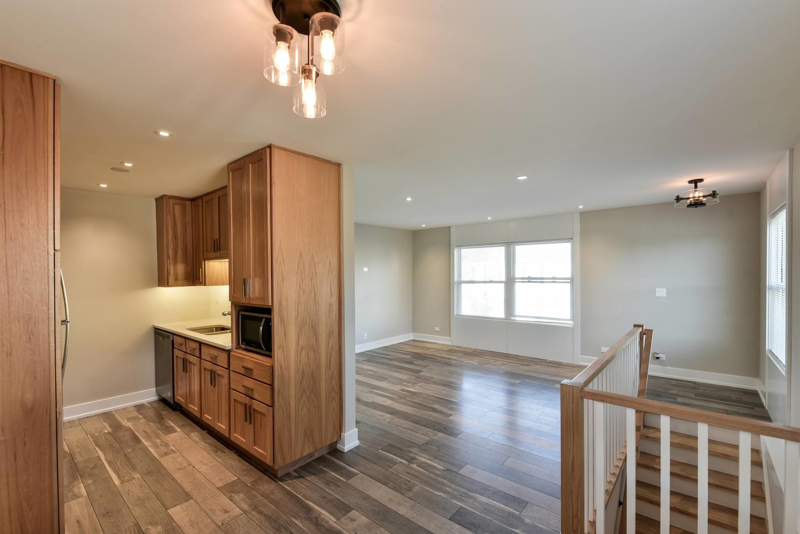 787 Pahl Road, Unit 787 Elk Grove Village, IL 60007 - Photo 7 of 28 a kitchen with stainless steel appliances granite countertop a refrigerator and a sink