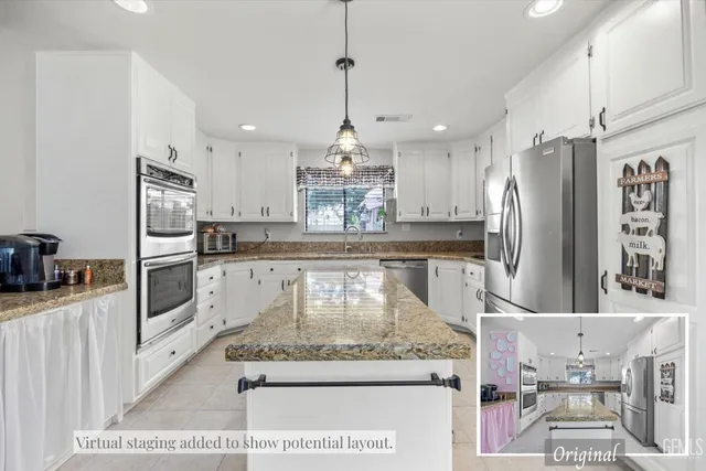 a kitchen with stainless steel appliances granite countertop a refrigerator a stove and a sink