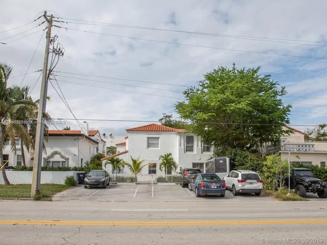 a view of a cars park in front of a house