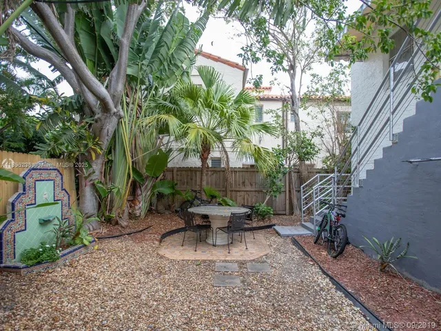 a view of a backyard with sitting area