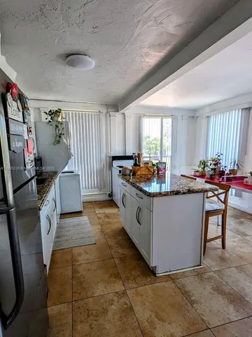 a room with granite countertop furniture and a flat screen tv