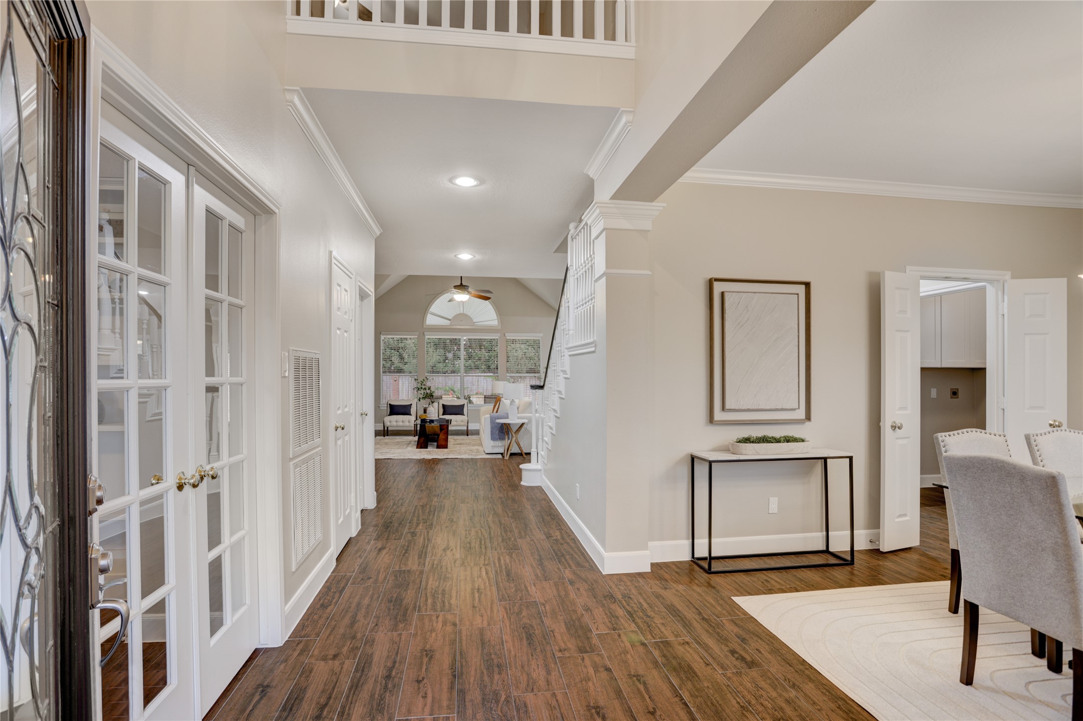 24418 Falcon Point Drive Katy, TX 77494 - Photo 3 of 40 Grand two-story foyer with soaring ceilings, wood-look flooring, and an open, light-filled layout. The elegant entry leads seamlessly into the main living area.