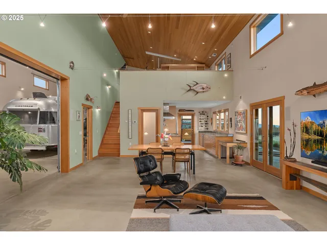 a living room with furniture a flat screen tv and a large window