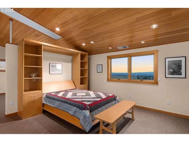 a living room with a table and a large window