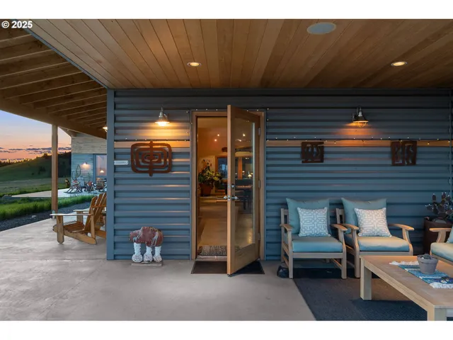 a view of a patio with table and chairs and a barbeque