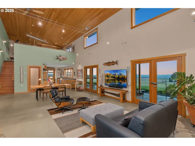 a living room with furniture gym equipment and a large window