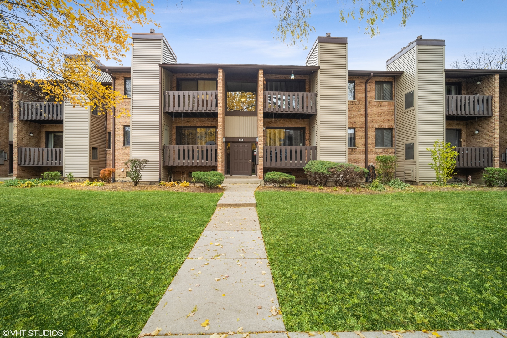 a front view of a brick house with a yard