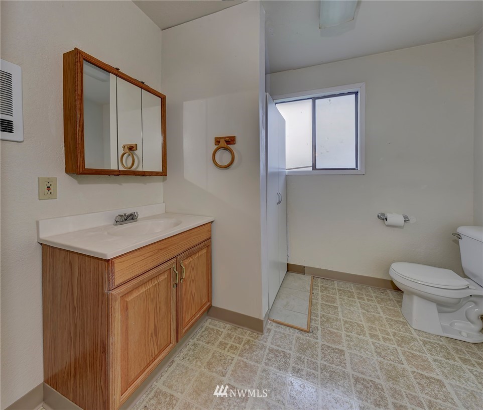 2801 Sierra Road Bremerton, WA 98310 - Photo 19 of 23 a bathroom with a sink a toilet and mirror