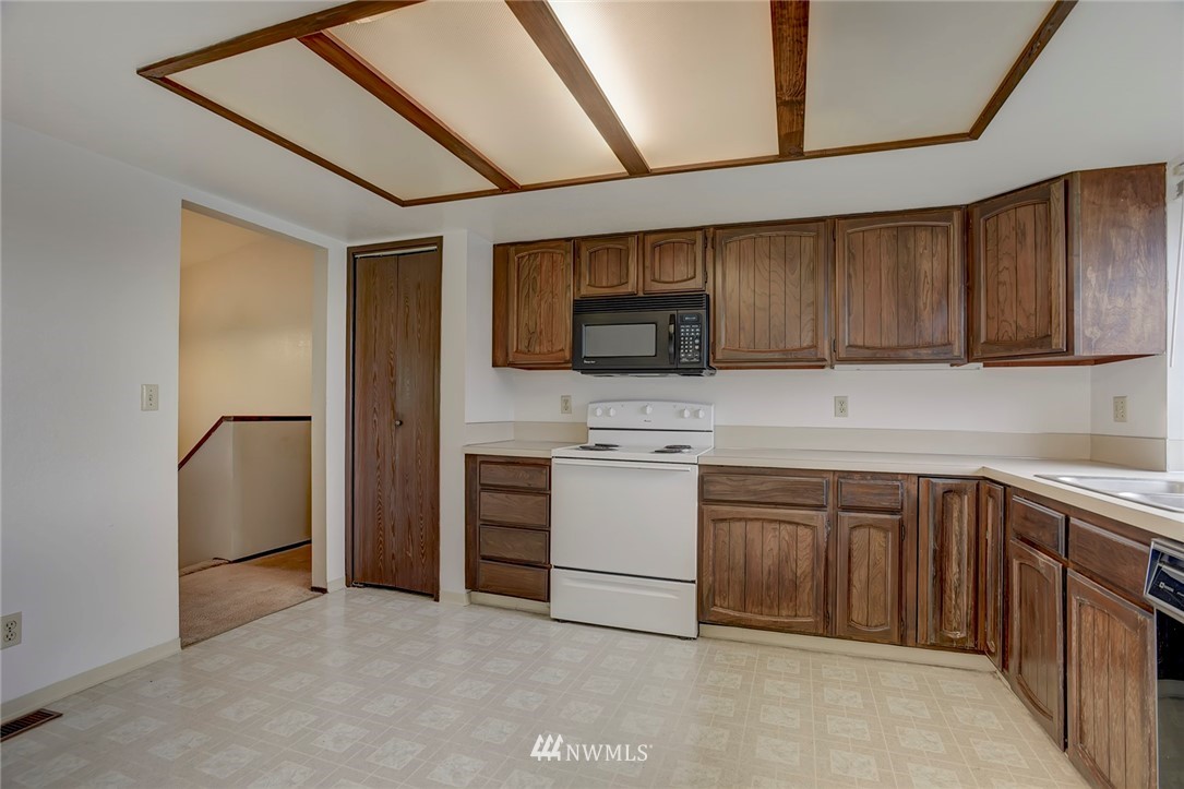 2801 Sierra Road Bremerton, WA 98310 - Photo 5 of 23 a kitchen with a sink stainless steel appliances and cabinets