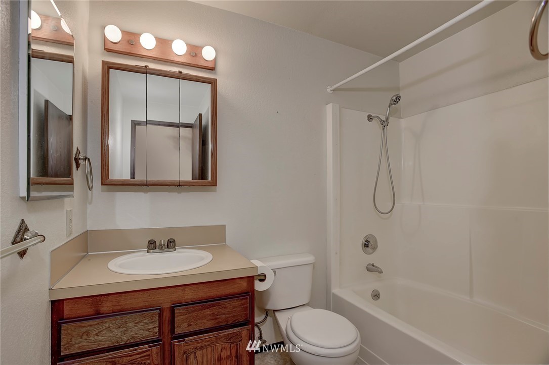2801 Sierra Road Bremerton, WA 98310 - Photo 7 of 23 a bathroom with a sink toilet a mirror and shower