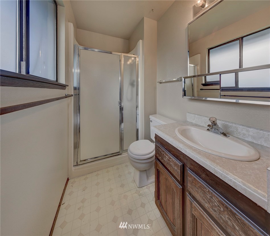 2801 Sierra Road Bremerton, WA 98310 - Photo 10 of 23 a bathroom with a granite countertop sink toilet and shower