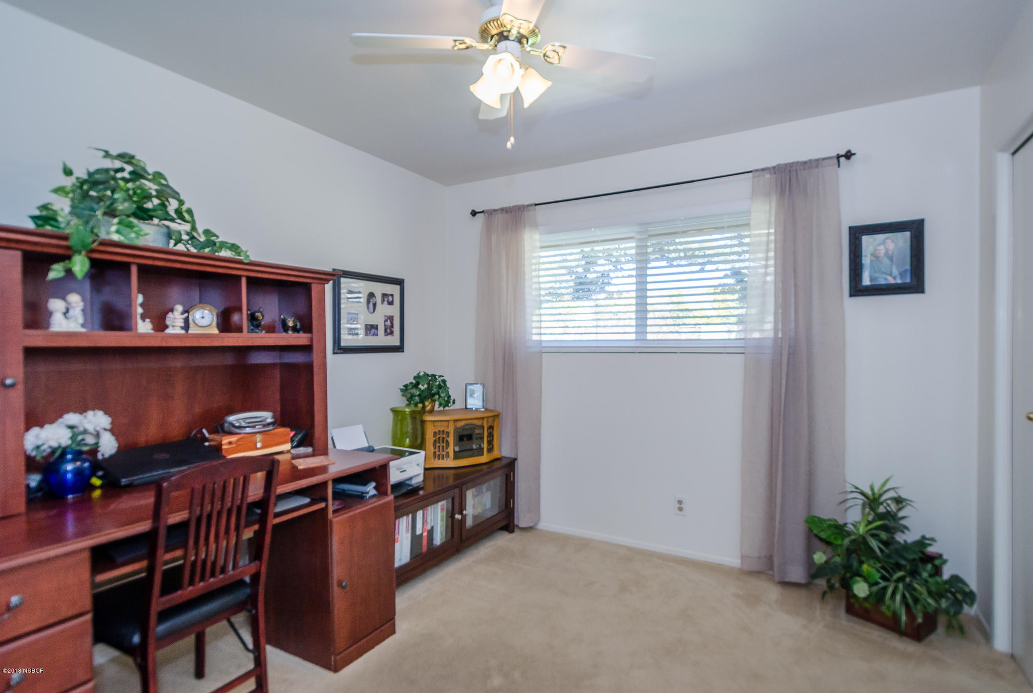 519 North Bradley Road Santa Maria, CA 93454 - Photo 13 of 27 a room with chandelier fan and wooden floor