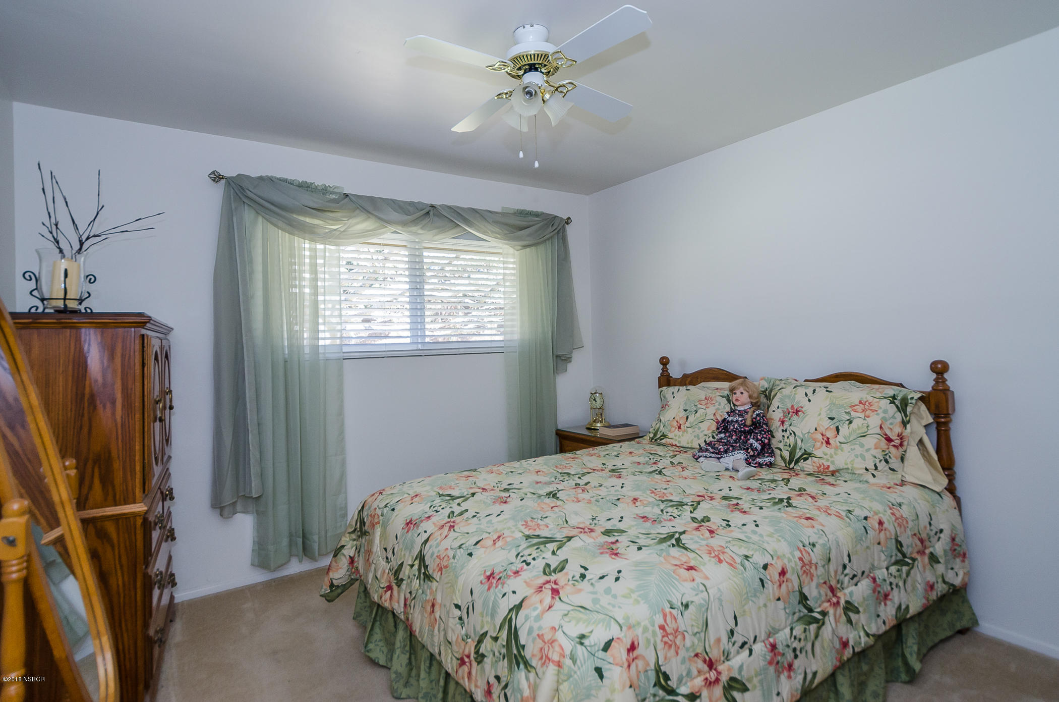 519 North Bradley Road Santa Maria, CA 93454 - Photo 15 of 27 a bedroom with a bed dresser and a window