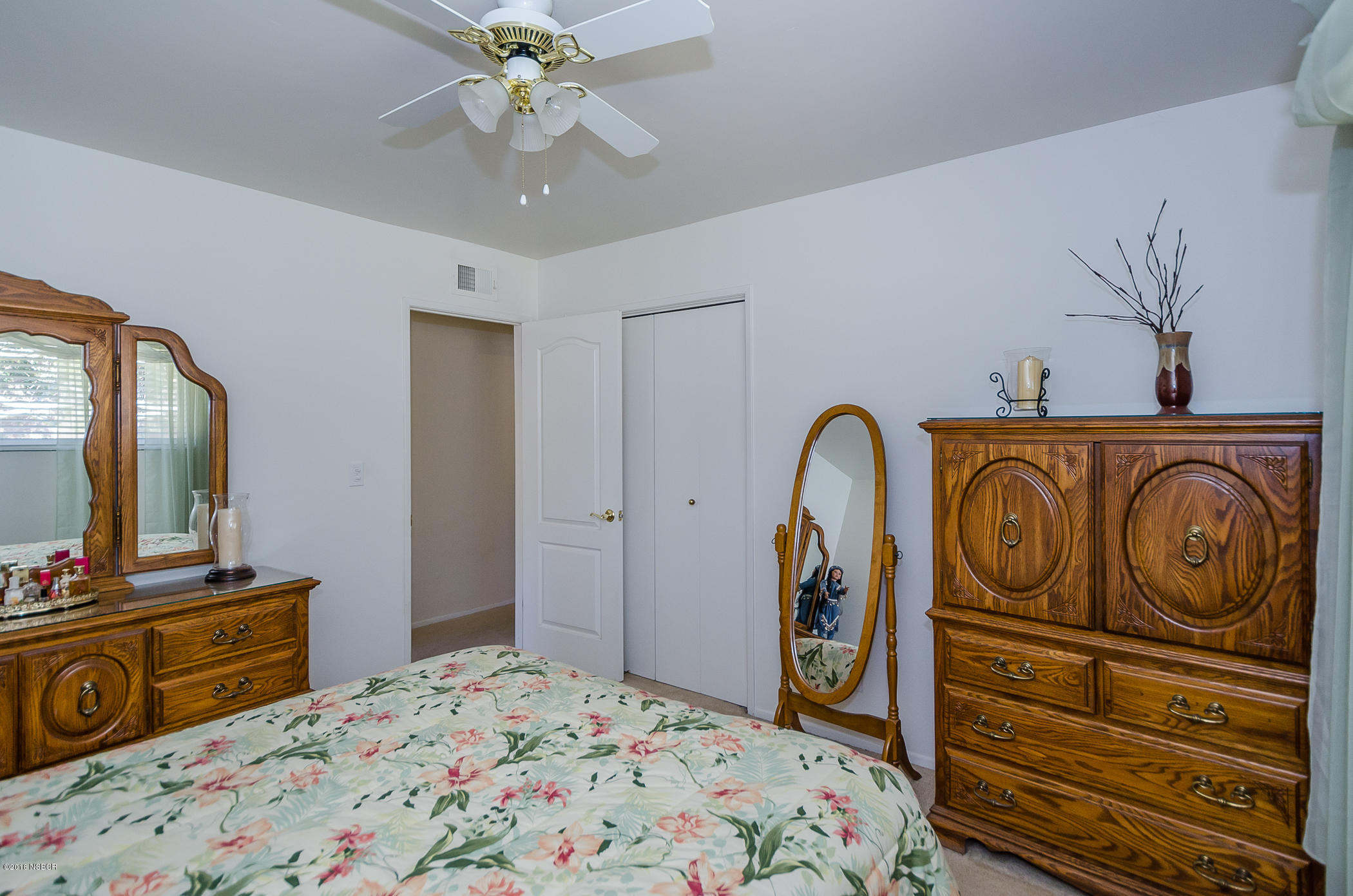 519 North Bradley Road Santa Maria, CA 93454 - Photo 16 of 27 a bedroom with a bed and a flat tv screen on dresser