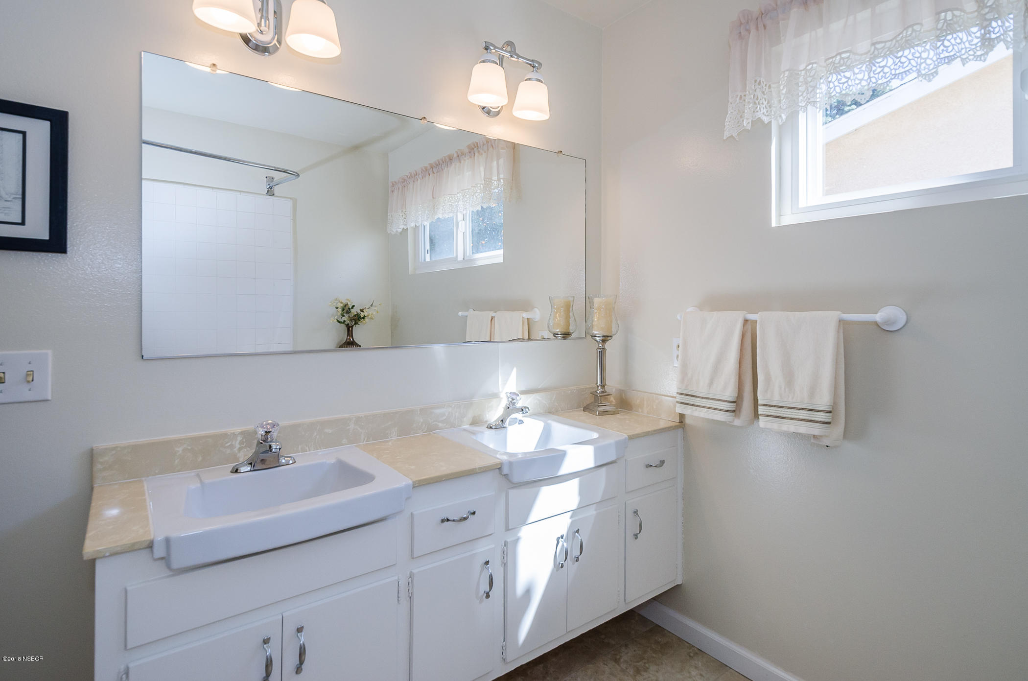 519 North Bradley Road Santa Maria, CA 93454 - Photo 18 of 27 a bathroom with a sink and a mirror