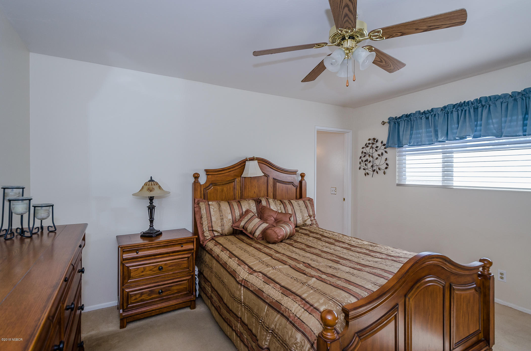 519 North Bradley Road Santa Maria, CA 93454 - Photo 19 of 27 a bedroom with a bed and a chandelier