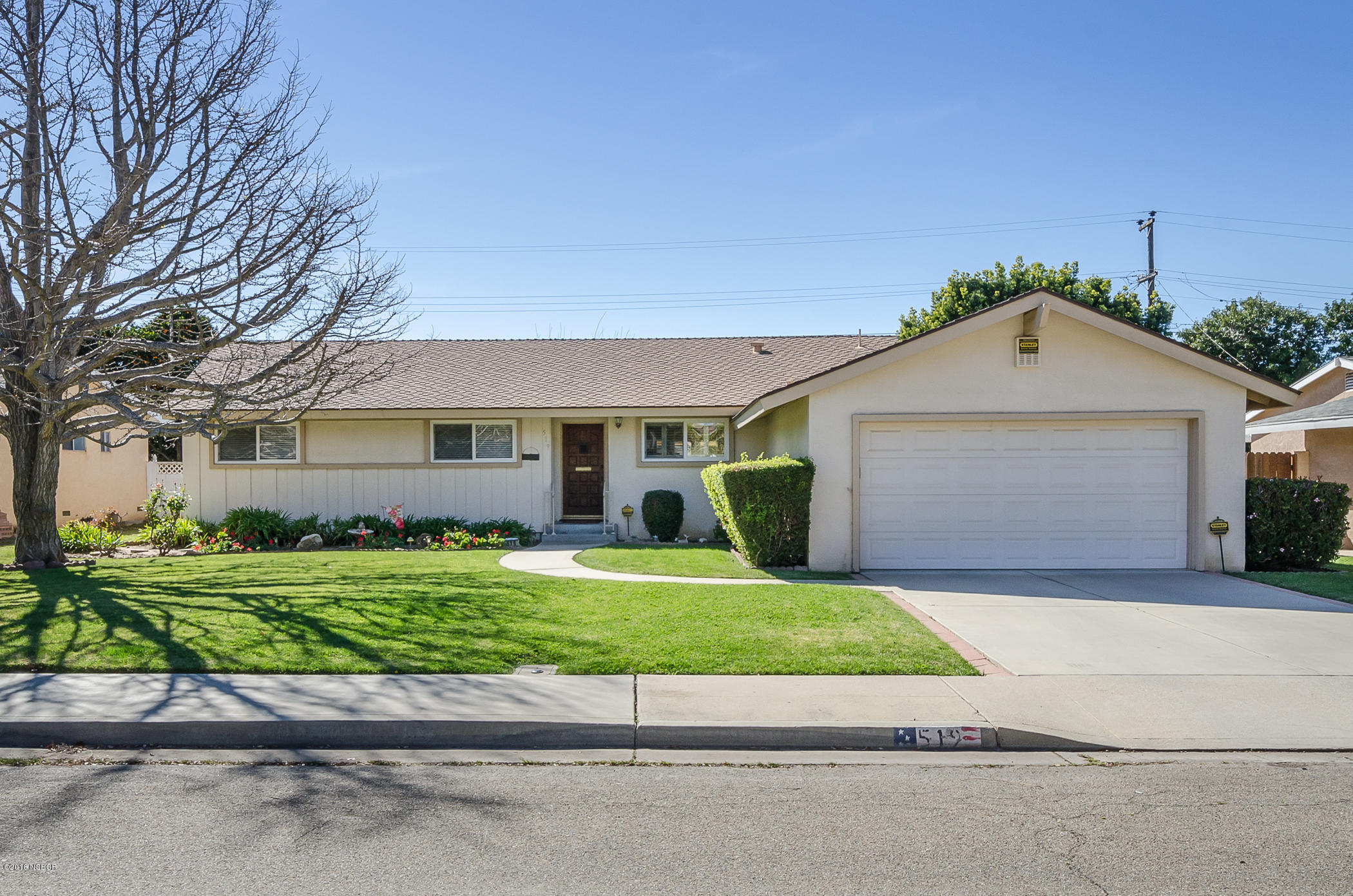 519 North Bradley Road Santa Maria, CA 93454 - Photo 2 of 27 a front view of a house with a yard and garage