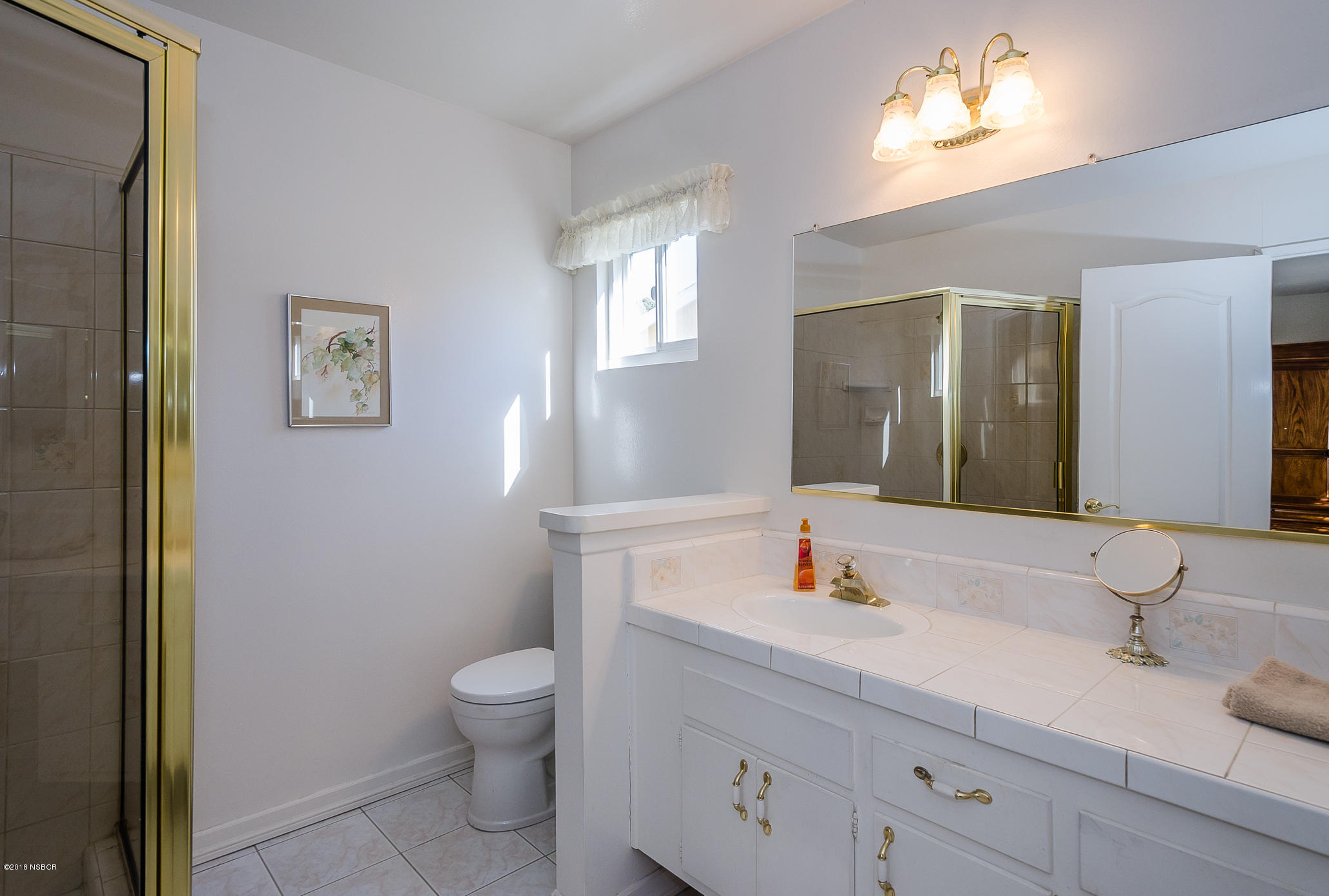 519 North Bradley Road Santa Maria, CA 93454 - Photo 21 of 27 a bathroom with a granite countertop sink toilet and a mirror