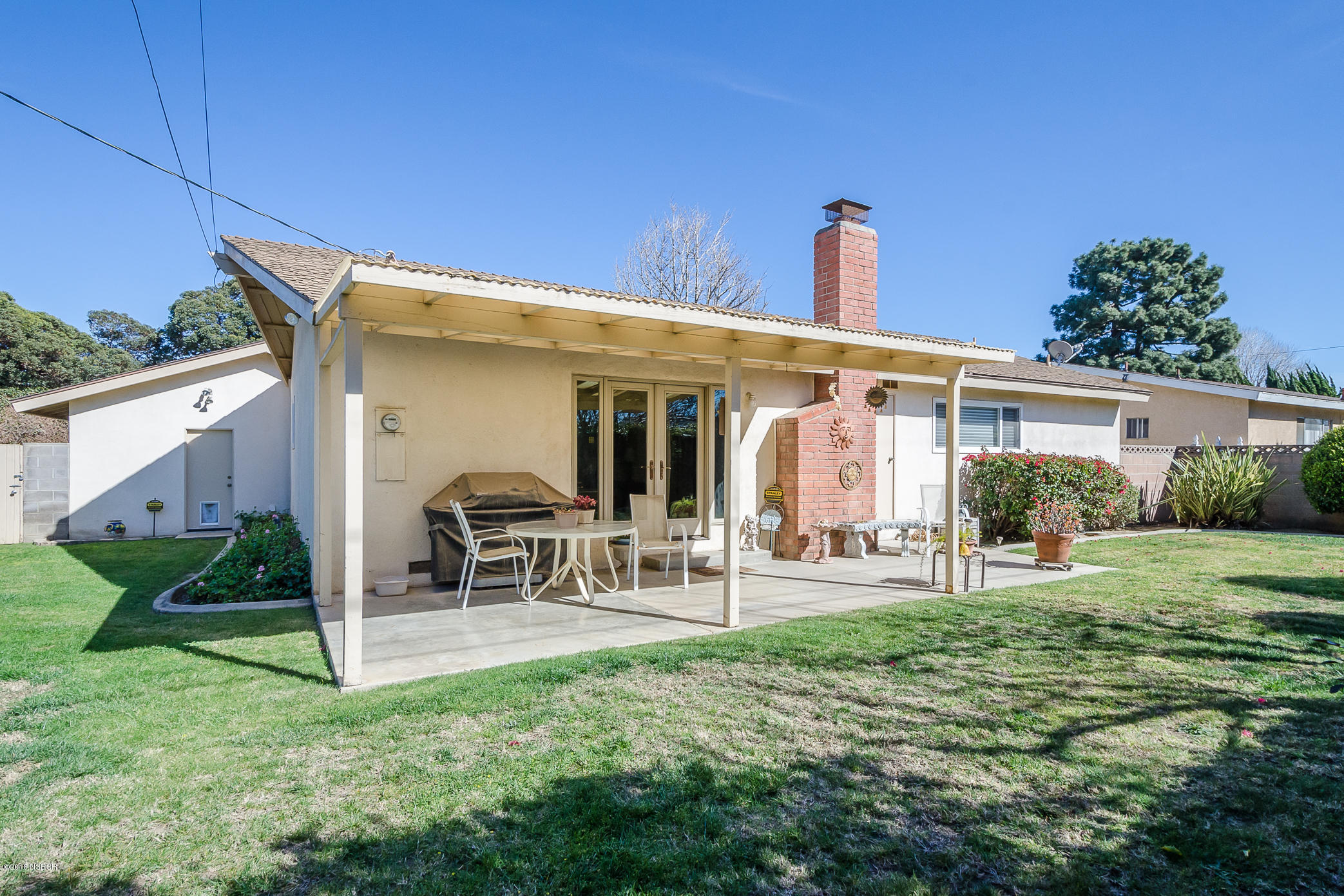 519 North Bradley Road Santa Maria, CA 93454 - Photo 25 of 27 a front view of a house with patio furniture and garden