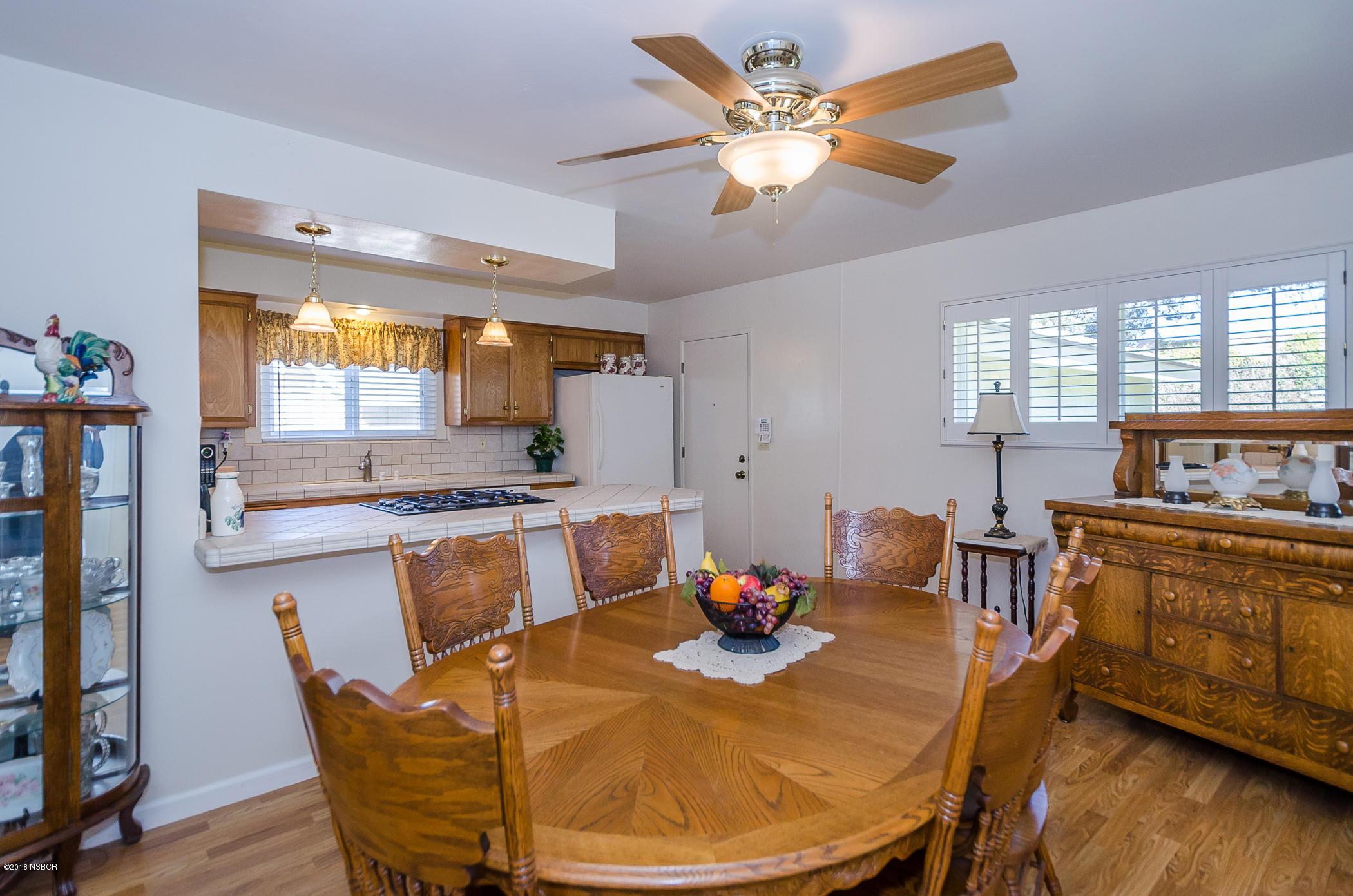 519 North Bradley Road Santa Maria, CA 93454 - Photo 4 of 27 a dining room with furniture a window and wooden floor