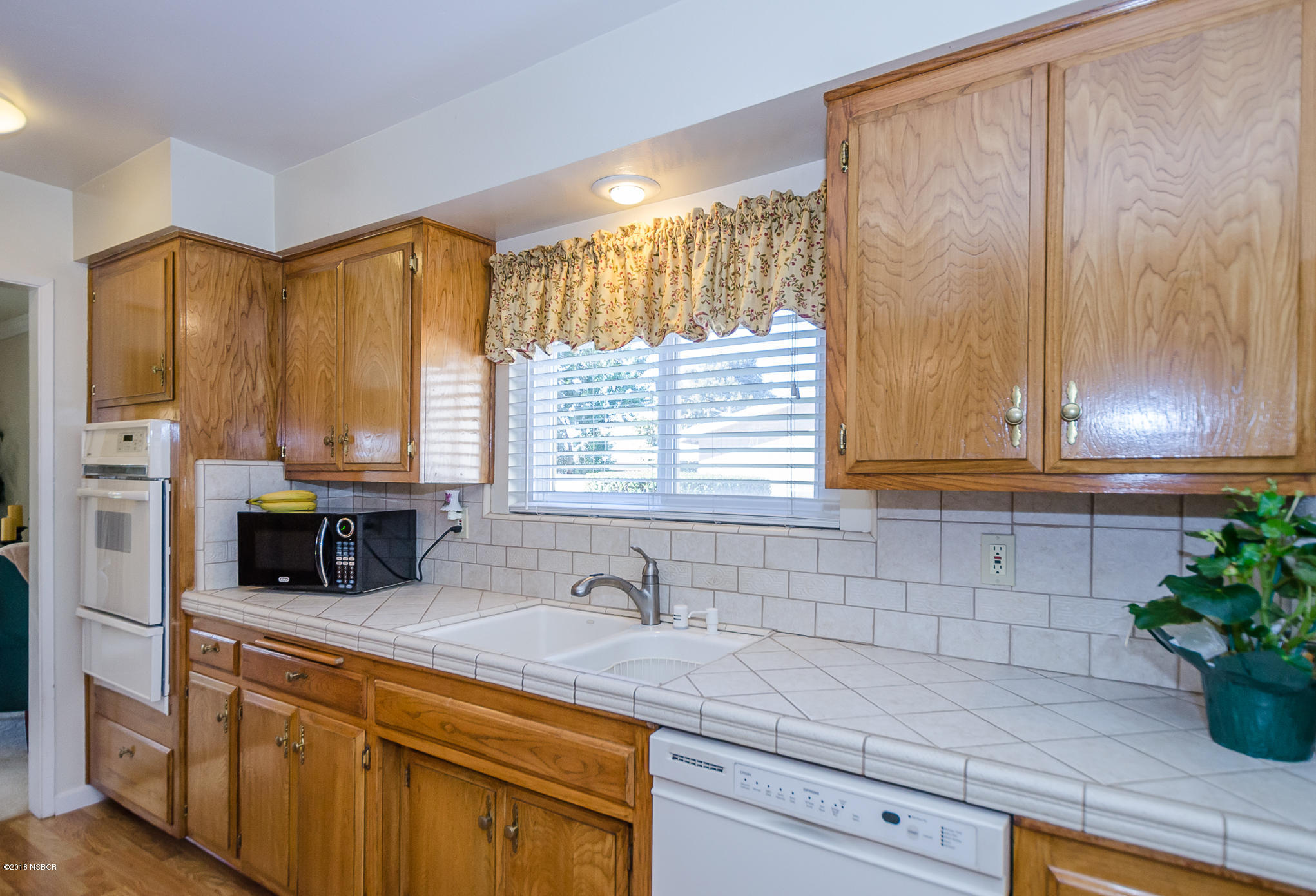 519 North Bradley Road Santa Maria, CA 93454 - Photo 8 of 27 a kitchen with stainless steel appliances a sink a large window and cabinets