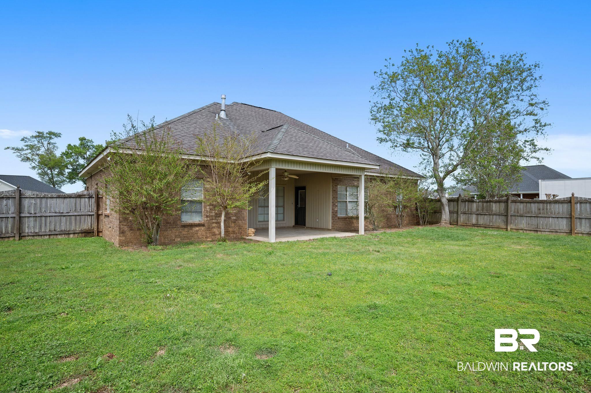 9837 Harmony Ridge Drive Semmes, AL 36575 - Photo 28 of 29 Rear view of property with a lawn, a fenced backyard, a patio, and a ceiling fan