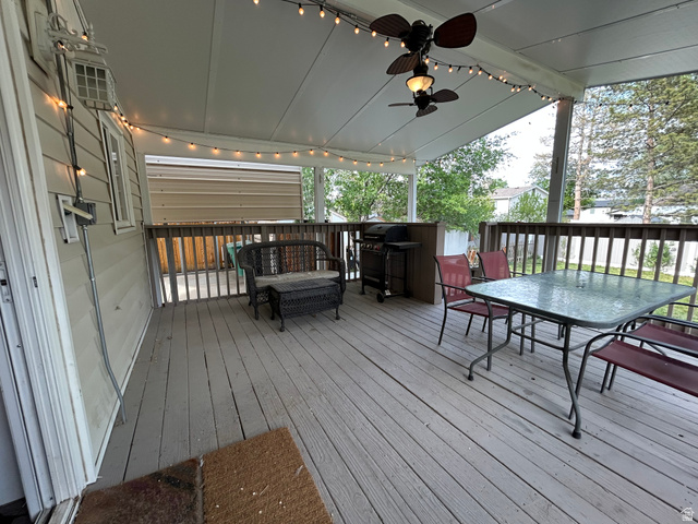 7659 State Street Midvale, UT 84047 - Photo 27 of 33 Wooden deck with a ceiling fan, grilling area, and outdoor dining area