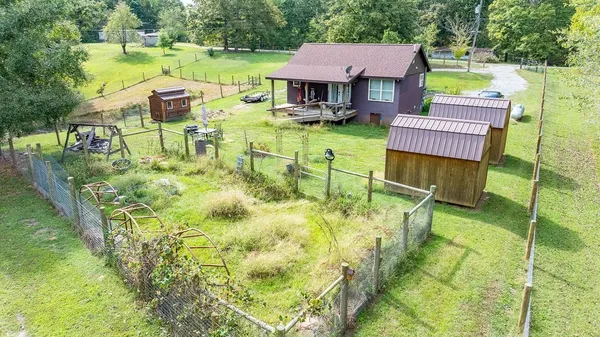 an aerial view of a house with swimming pool garden and patio