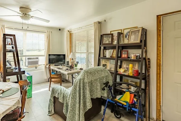 a view of a workspace with furniture and a window