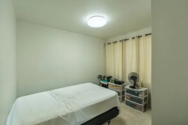 a bedroom with a bed and a chair