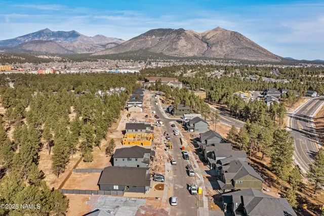 an aerial view of residential house and sandy dunes