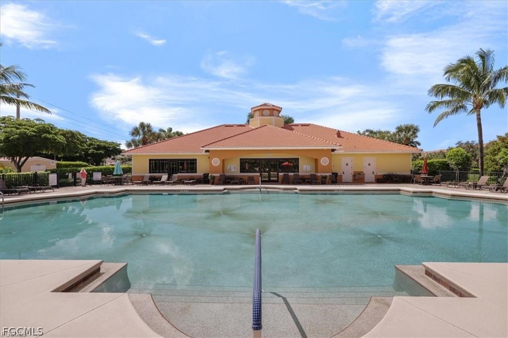 8261 Pathfinder Loop, Unit 738 Fort Myers, FL 33919 - Photo 18 of 22 a view of a swimming pool and a terrace