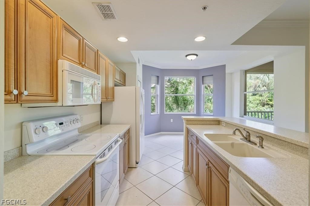 8261 Pathfinder Loop, Unit 738 Fort Myers, FL 33919 - Photo 2 of 22 a kitchen with a sink stove and cabinets