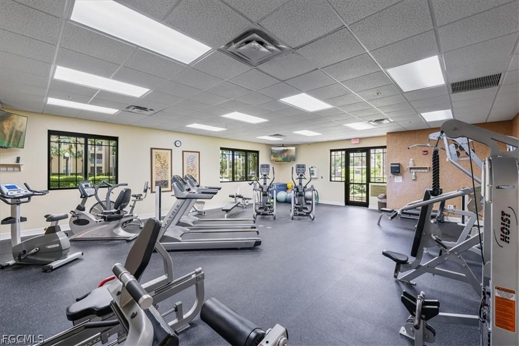 8261 Pathfinder Loop, Unit 738 Fort Myers, FL 33919 - Photo 21 of 22 a living room with furniture gym equipment and a large window