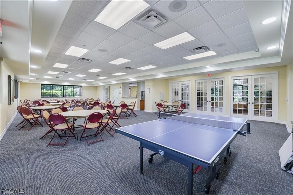 8261 Pathfinder Loop, Unit 738 Fort Myers, FL 33919 - Photo 22 of 22 a room with lots of furniture a table and a chandelier