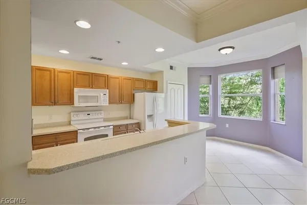 a large white kitchen with a large window