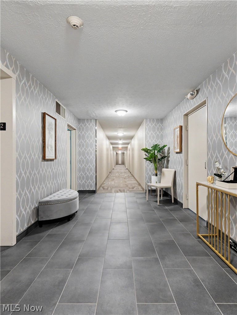 3064 Kent Road Stow, OH 44224 - Photo 24 of 30 Long hallway featuring tiled flooring, patterned wallpaper, and recessed lighting