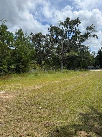 a view of yard with wooden fence