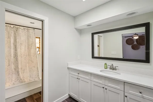 a bathroom with a sink mirror and vanity
