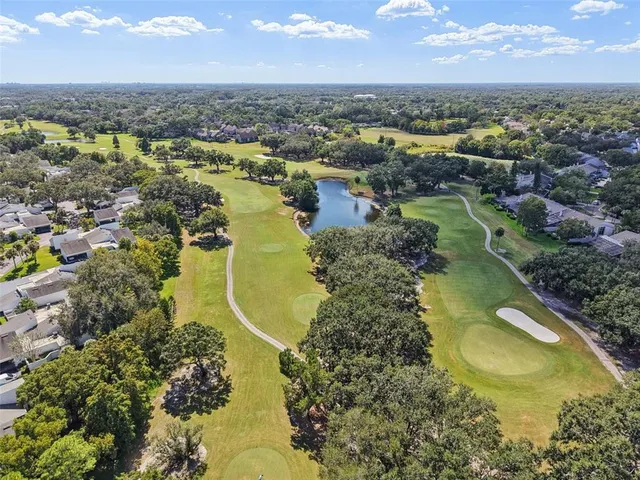 an aerial view of a house with garden space and street view