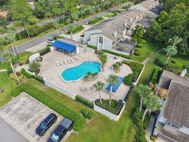 a view of a house with a swimming pool and sitting area