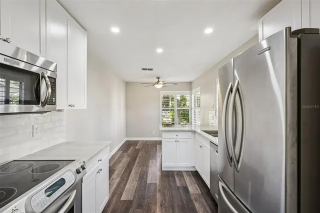 a kitchen with stainless steel appliances a refrigerator and a sink